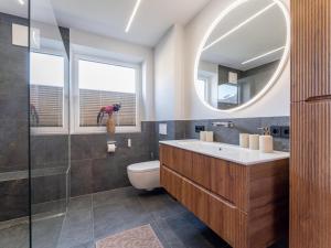 a bathroom with a sink and a toilet and a mirror at Bruggerheim in Niedernsill +47 photos