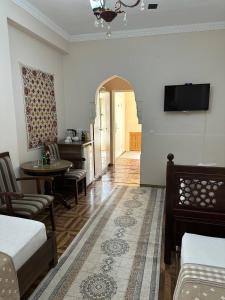 a room with a bed and a table and a kitchen at OROM PONORAMA VIEW old city in Bukhara