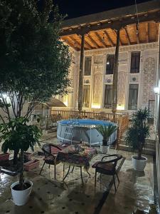 a patio with a table and chairs in front of a building at OROM PONORAMA VIEW old city in Bukhara