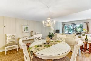 a dining room and living room with a table and chairs at 2060 Beach Wood in Amelia Island