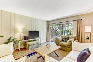 a living room with a couch and a table at 2060 Beach Wood in Amelia Island +42 photos