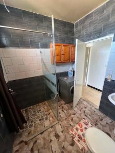 a bathroom with a shower and a toilet and a sink at maison hajji in Mezraya +8 photos