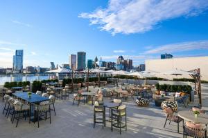 a patio with tables and chairs with a view of the city at Baltimore Marriott Waterfront in Baltimore