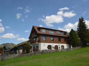 a large house on top of a green field at Passhöhe in Hohentauern
