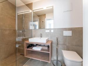 a bathroom with a sink and a toilet and a mirror at Passhöhe in Hohentauern +21 photos