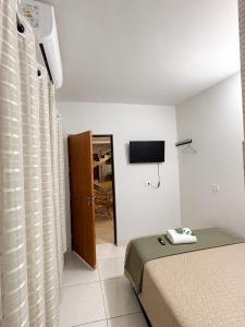a hotel room with a bed and a television at Hotel Classic in Porangatu