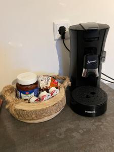 a coffee maker sitting next to a basket of food at Ferienwohnung Emerson in Edemissen +7 photos