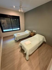 a room with two beds and a window at Casa Las Moras in Santiago del Estero
