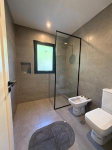 a bathroom with a shower and a toilet and a sink at Casa Las Moras in Santiago del Estero