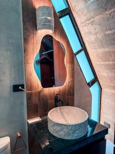a bathroom with a large stone sink on a counter at Danselis Boutique Hotels in Telchac Puerto