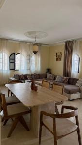 a living room with a table and a couch at villa Oasis Rouge Sable in Marrakesh