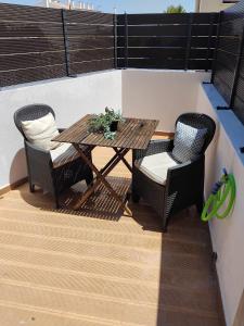 a wooden table and chairs on a balcony at Cozy Burgau in Burgau +1 photo