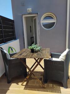a wooden table with a potted plant on it at Cozy Burgau in Burgau