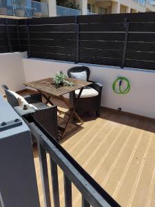 a table and chairs on a balcony with a table at Cozy Burgau in Burgau