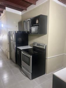 a kitchen with a stove and a refrigerator at Manor Villas in Kingston +17 photos