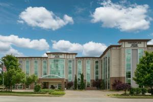 a large office building with clouds in the sky at TownePlace Suites by Marriott Springfield in Springfield