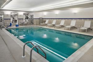 a large swimming pool with chairs in a gym at TownePlace Suites by Marriott Springfield in Springfield