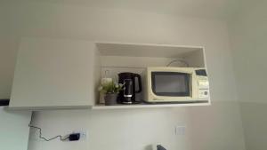 a microwave sitting on a shelf in a kitchen at Julieta in La Rioja