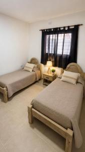 a bedroom with two beds and a window at Julieta in La Rioja