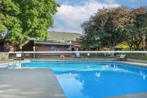 a swimming pool with blue water in a yard at Best Western Sunridge Inn & Conference Center in Baker City