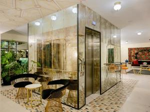 a large room with a walk in shower next to a walk in shower at Museum Hotel in Tbilisi City