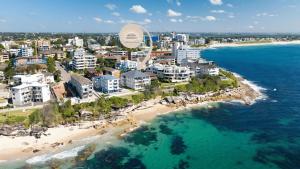 an aerial view of a beach with buildings and the ocean at Esplanade Bliss in Cronulla