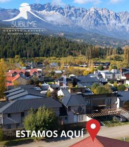 an aerial view of a town with mountains in the background at Cabañas Sublime Bolson in El Bolsón +31 photos