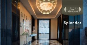 a lobby of a hotel with a chandelier at Hotel on Boulevard in Johannesburg