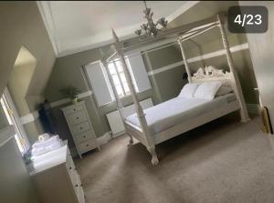 a bedroom with a white canopy bed and a window at Dundee Beds in Dundee
