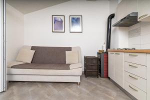 a living room with a couch and a kitchen at Seaside secluded apartments Cove Virak, Hvar - 12321 in Gdinj
