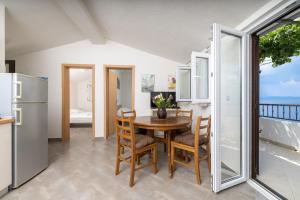 a kitchen and dining room with a table and chairs at Seaside secluded apartments Cove Virak, Hvar - 12321 in Gdinj +17 photos