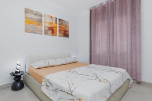 a bedroom with a bed and a window at Apartments by the sea Balica Rat, Omis - 1065 in Omiš