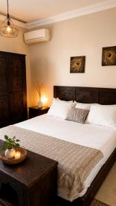 a bedroom with a large bed and a table at villa Oasis Rouge Sable in Marrakesh +65 photos