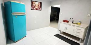 a kitchen with a blue refrigerator and a sink at Aliança da Fé in Cachoeira Paulista +12 photos