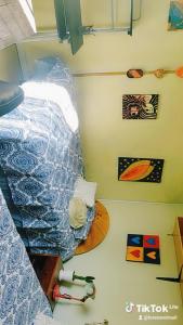a bedroom with a bed and a surfboard on the floor at Lamaison in Talca