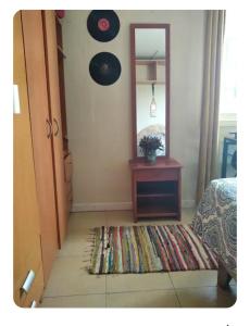 a bedroom with a mirror and a rug on the floor at Lamaison in Talca