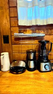 a counter with a blender and other appliances on it at VENTO A GOSTO Chalet - Atins in Atins