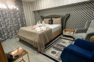 a bedroom with a bed with two candles on a table at Kral As Suite Hotel in Istanbul