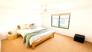 a bedroom with a bed and a window at Blue Bay Escape in Venus Bay
