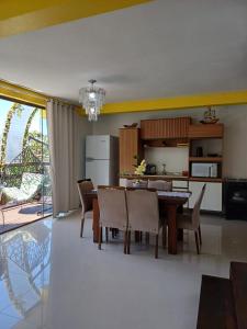 a kitchen and dining room with a table and chairs at Suíte com vista panorâmica in Bombinhas