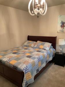 a bedroom with a bed with a quilt on it at Abundant life in Arlington
