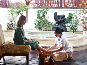 two women sitting on the floor in front of a fountain at Novotel Bali Nusa Dua in Nusa Dua +142 photos