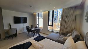 a living room with a couch and a room with a table at Adagio Quito Coliving Ecuador Residences in Quito
