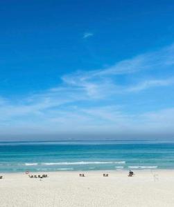a beach with the ocean and a blue sky at Bianki vip villa in Alexandria