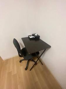 a black table with a chair in a room at メープル桑園駅311 in Sapporo