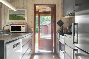 a kitchen with a sink and a microwave at 30306-Odder-Hougaardsvej-6-A in Odder +18 photos