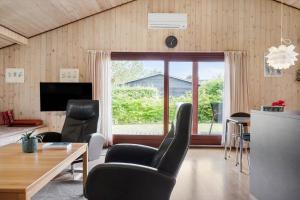 a living room with a table and chairs and a large window at 30306-Odder-Hougaardsvej-6-A in Odder