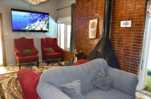 a living room with a couch and a flat screen tv at Bianki vip villa in Alexandria