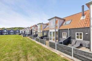 a row of houses with a lawn in front at 40128-Juelsminde-Strandengen-41 in Juelsminde