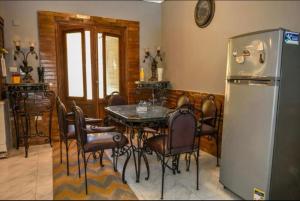a dining room with a table and a refrigerator at Bianki vip villa in Alexandria